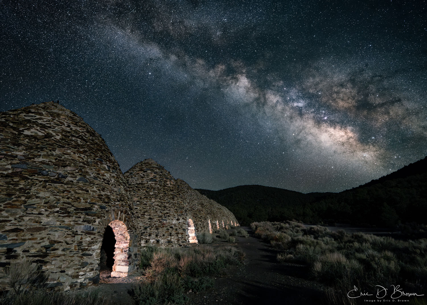 Milky Way galactic core rising over a dark landscape — the kind of shot careful planning makes possible